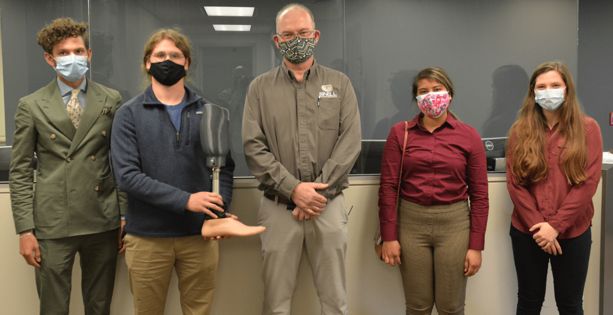 Greg Johnson of Snell Prosthetics & Orthotics (center) and UA biomedical engineering students (left to right) Seth Box, Kyle Potts, Nathalie Cedeno and Reagan Dugan show off the prosthesis they designed
